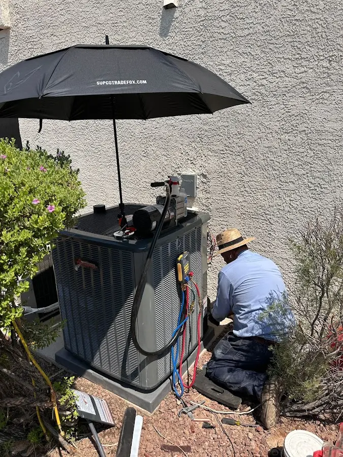 HVAC technician performing outdoor AC maintenance in Hercules