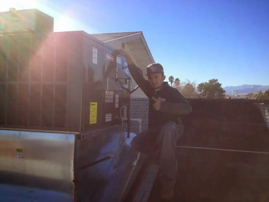 HVAC technician performing Boiler Repair on a rooftop unit in Hercules